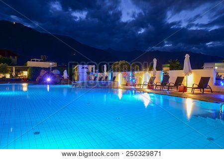 Swimming Pool At A Luxury Resort By Night In Lana