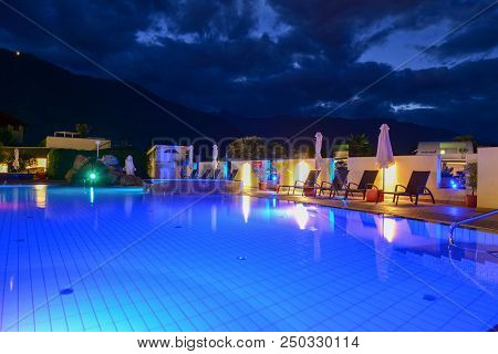 Swimming Pool At A Luxury Resort By Night In Lana