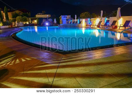 Swimming Pool At A Luxury Resort By Night In Lana