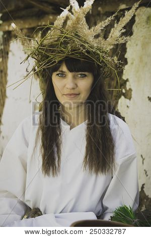 Girl Druid Healer With A Wreath Of Wild Flowers On His Head Holding A Bunch Of Herbs In His Hands An