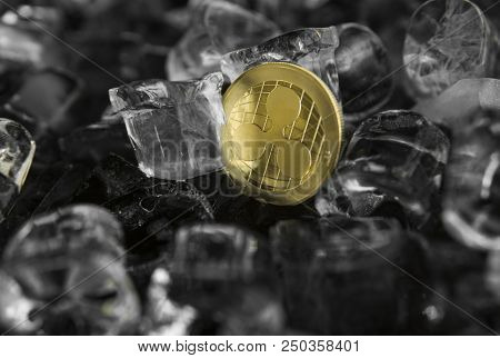 Gold Ripple Coin On Ice Background. The Concept Of The Exchange In Winter. Freeze. Blockchain Mining