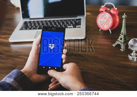 Chiang Mai, Thailand - July 07,2018: Man Hands Holding Sony Mobile With Dropbox On The Screen. Dropb