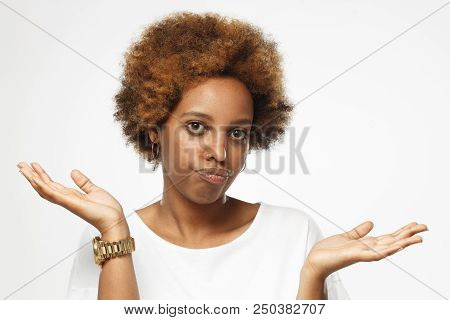 I Don't Know. Young Afrcian American Woman Isolated On Grey Background, Showing Helpless Gesture Wit
