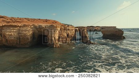 Aerial Photography.huge Stones Lie In The Sea. One Wave Rolls On The Other. Waves Break Against Ston
