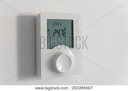 Temperature Controller, Electronic Thermostat With A Screen On The Wall Of A New Apartment.