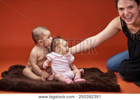 Two Small Kids Look At Smiling Momin Syudio Background