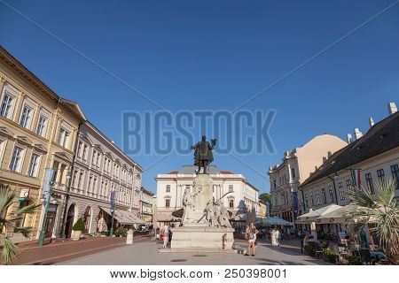 Szeged, Hungary - July 2, 2018: People Standing Near Kossuth Lajos Sttatue In The City Center Of Sze