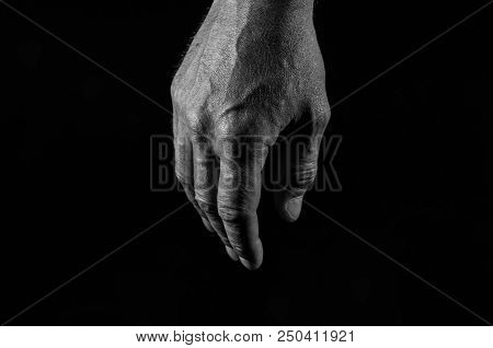Monochrome Image ,tired Caucasian Male Hand Isolated On Black Background.