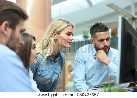 Group Of Young Modern People In Smart Casual Wear Having A Brainstorm Meeting While Standing In The 