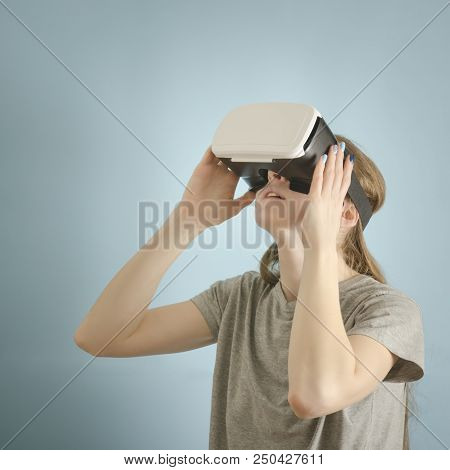 Yuong Woman With Glasses Of Virtual Reality. Blue Background
