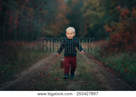 Adorable Boy Waiting For The Train With Suitcase