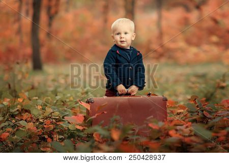 Adorable Boy On A Railway Station, Waiting For The Train With Suitcase