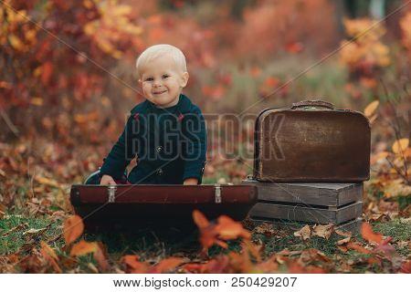 Adorable Boy On A Railway Station, Waiting For The Train With Suitcase