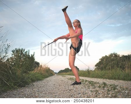 Teen Majorette Girl Twirling Baton Outdoors