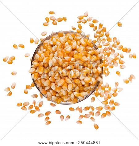 Unpopped Popcorn In Bowl And Spilled Around It, Isolated On White Background, Top View