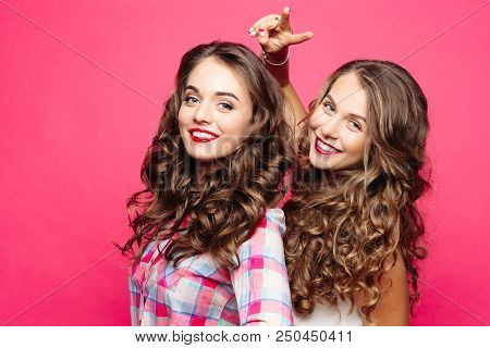 Two Pretty Happy Girls With Curly Hair And, Make Up After Beauty Salon, Smiling And Showing Peace By