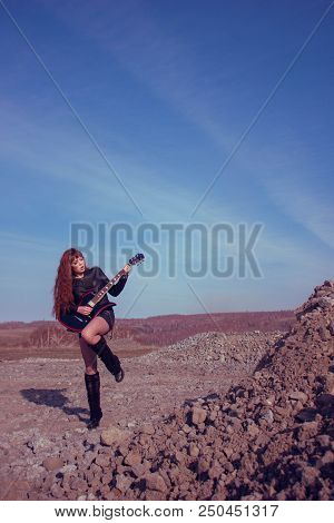 Beautiful Girl In Leather Jacket With Guitar