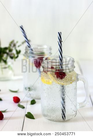 A Cooling Lemon Drink In A Glass Cup On A Wooden Table