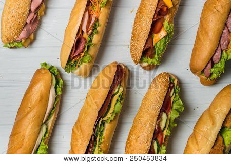 Fresh Sub Sandwich On White And Wheat Hoagies.