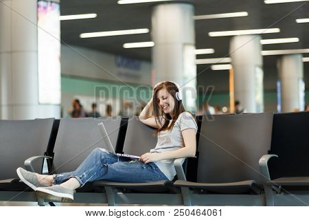 Young Beautiful Traveler Tourist Woman With Headphones Listening Music Working On Laptop, Wait In Lo