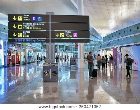 Passengers In Transit In A Terminal Of Barcelona International Airport.