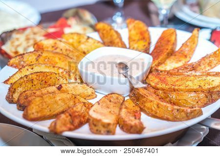 Fried Potatoes With Mexican Sauce On The Plate