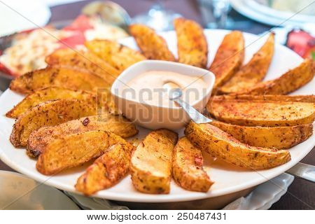 Fried Potatoes With Mexican Sauce On The Plate