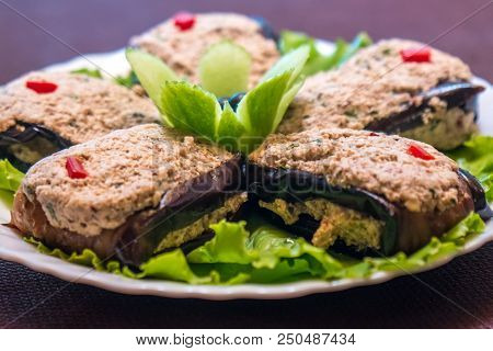 Roasted Eggplants And Peppers Stuffed With Nuts On A Plate