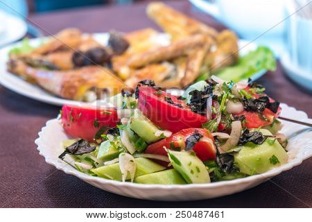 Tomato And Cucumber Salad With Onion, Pepper And Parsly