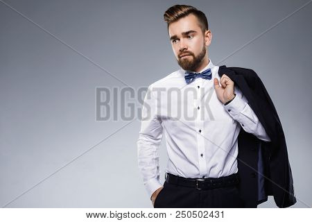Stylish Handsome Man Wearing A Classic Suit With Bow-tie