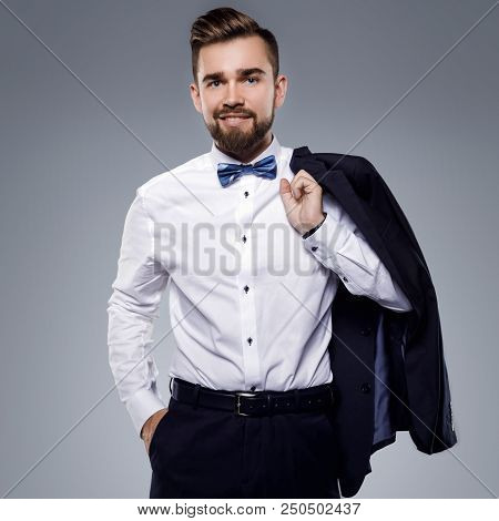Stylish Handsome Man Wearing A Classic Suit With Bow-tie