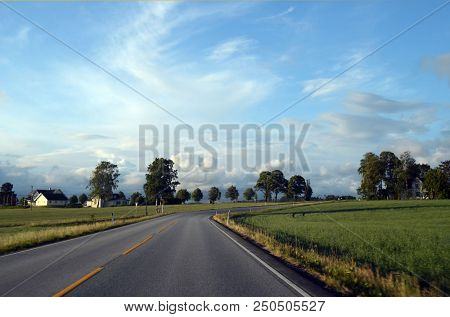 
A typical Norwegian road in the countryside. June 16. 2018. Ostfold Region, Norway
