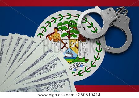 Belize Flag  With Handcuffs And A Bundle Of Dollars. The Concept Of Illegal Banking Operations In Us