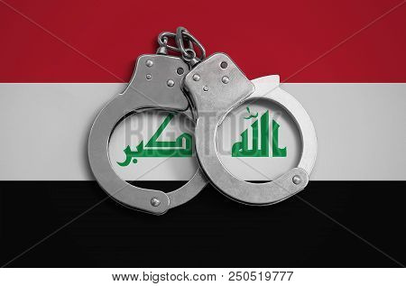 Iraq Flag  And Police Handcuffs. The Concept Of Observance Of The Law In The Country And Protection 