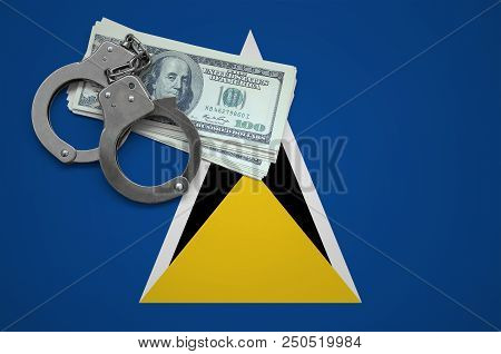 Saint Lucia Flag  With Handcuffs And A Bundle Of Dollars. The Concept Of Breaking The Law And Thieve