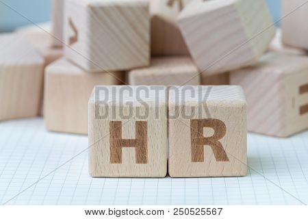 Wooden Cube Block Building The Word Hr At The Center On Grid Line Note Book With Random Other Blocks