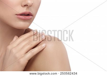 Cropped Frontview Of Model Touching Her Shoulder Tenderly. Having Smooth, Healthy Skin Tone. Feminin
