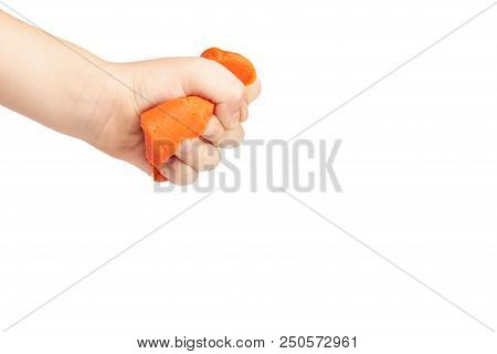 Orange Plasticine Bar With Kid Hand, Isolated On White Background. Copy Space Template.