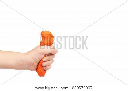 Orange Plasticine Bar With Kid Hand, Isolated On White Background. Copy Space Template.