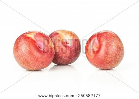 Group Of Three Whole Fresh Pluot Interspecific Plums Variety Isolated On White