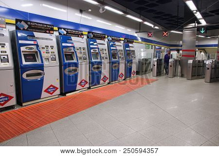 Madrid, Spain - October 21, 2012: People Walk By Ticket Machines At Madrid Metro. Madrid Metro Has A