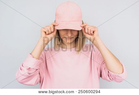 Closeup Portrait Of Caucasian Blonde Young Female Wearing Pink Sweater And Cover Her Eyes With Pink 