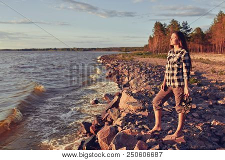 Young Woman Walking Along Great Salt Lake Beach. Landscape With People And Copy Space.
