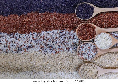 Food Background With Top View Of Five Rows Of Rice In A Wooden Spoon.
