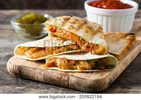 Mexican Quesadilla With Chicken, Cheese And Peppers On Wooden Table.
