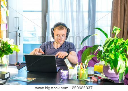 Emotional Man In Headphones Looking At Computer Screen, Gestures And Participating In Online Meeting