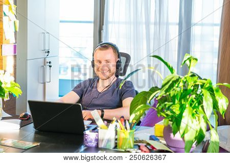 Emotional Man In Headphones Looking At Computer Screen, Gestures And Participating In Online Meeting