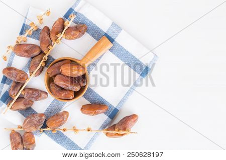 Dates Fruit In Wooden Ladle On White Background,dried Date Palm Fruits Top View