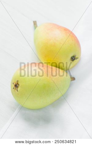 Beautiful Autumnal Background. Ripe Organic Pears Of Pastel Colors Yellow Red Green On White Linen C