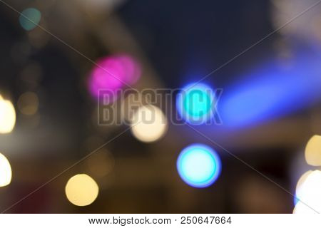 Many Blurred Small Electric Bulbs. A Blurry Photo Of The City